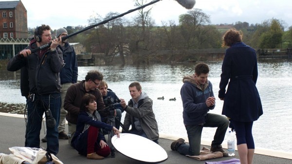 Georgina Sherrington and Oliver Park rehearse lines for a scene with coats on to protect them from the chill. Just before filming, they removed them.