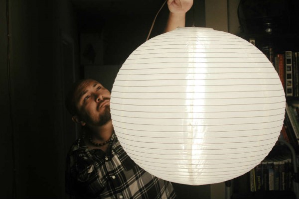 Filmmaker Andrew Bliss creating a soft light with a china ball.