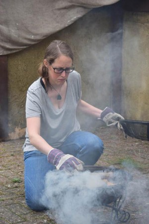 Production assistant Claire Finn tends the brazier which provides smoke in the absence of a smoke gun.