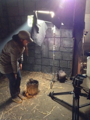 A fluorescent toplight rigged over the bucket for the face-washing close-up. Note the black cloth hanging from one side to reduce spill.