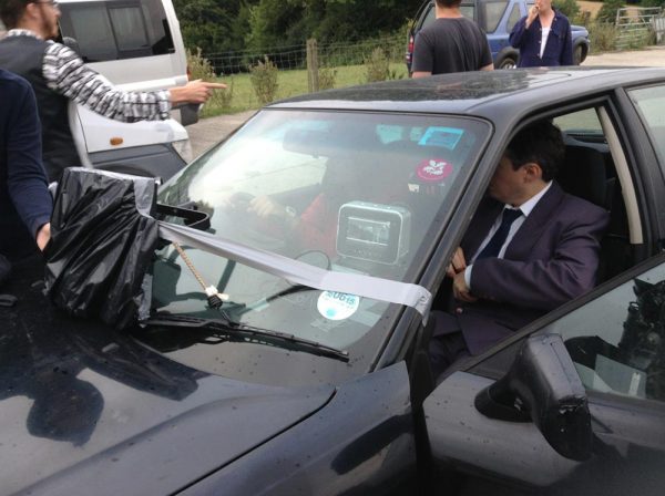 Under the black bag is an LP-1×1 LitePanel to keep some consistency to the light on the actors as the car moves, in this scene from The Gong Fu Connection.